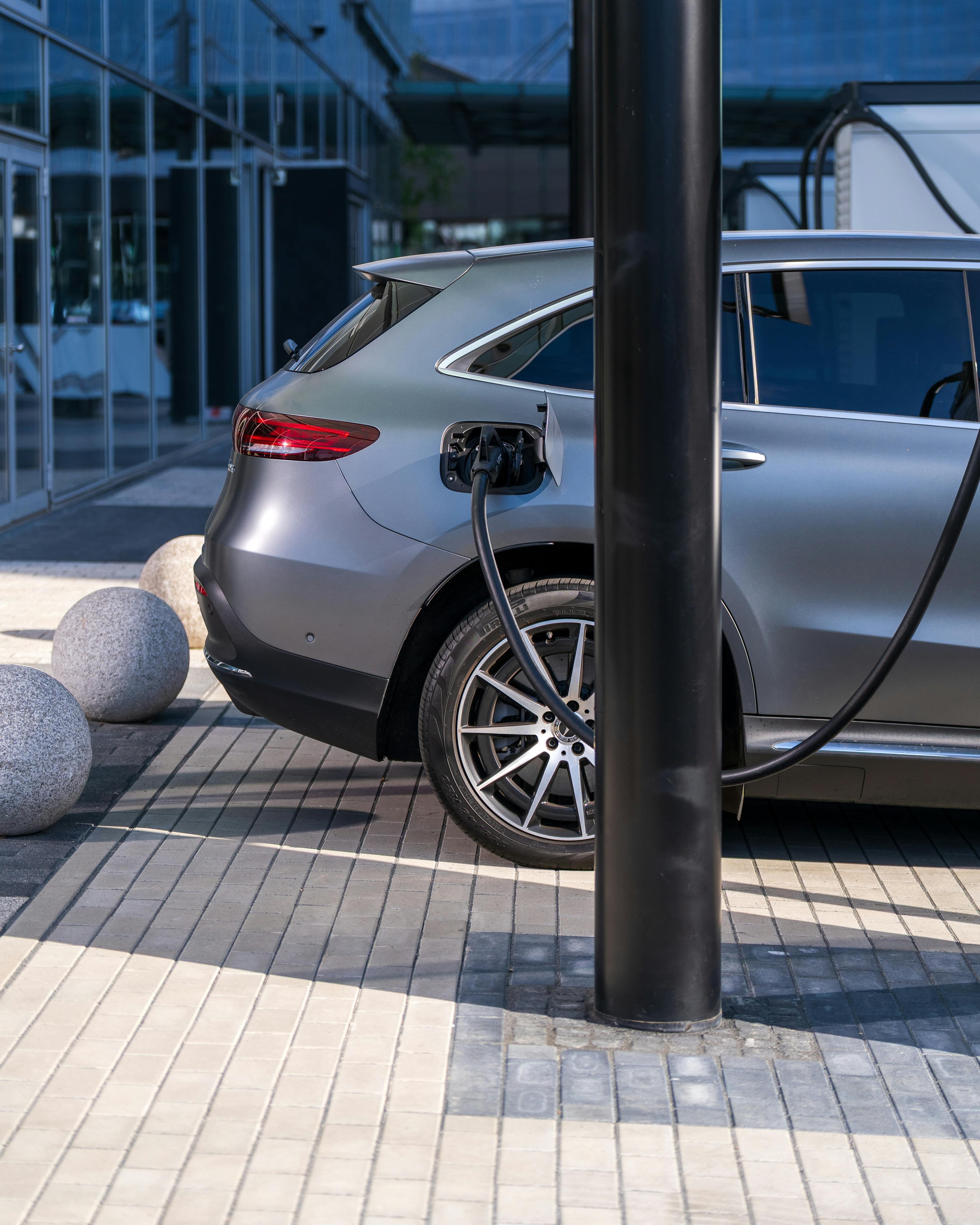 Fuel station with high prices next to an electric car charging